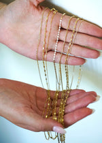 Sb Studio Aniya bi-colour 10k yellow and white gold cable chain necklace held in hands