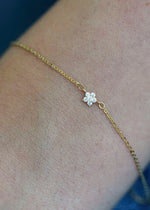 Sb Studio Fleur charm bracelet in 14k yellow gold featuring a delicate flower with white topaz gemstones.