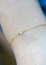 Sb Studio 14k yellow gold bracelet featuring a delicate bezel-set heart-shaped opal charm on a cable chain.