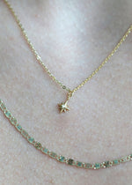 Sb Studio 14k yellow gold North Star charm pendant with a small diamond, worn on a delicate chain.