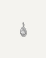 Sb Studio Silver Poet Pendant featuring a small oval sterling silver charm with an engraved paw print design.