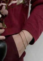 Person wearing solid gold bracelet and bezel diamond tennis bracelet from SB Studio in Alberta Canada