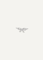 Silver bow-shaped charm on a white background