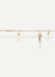 Gold bracelet with 'MAMA' and star, key, and heart charms on a white background from sb studio formerly the sparkle bar