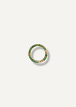 Gold charm holder with green gemstones on a white background from SB Studio in Edmonton