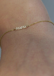 solid 14k Gold bracelet with 'MAMA' on a wrist against a neutral background from the sparkle bar