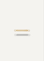 solid 14k Gold bar-shaped engravable charm jewelry piece on a white background