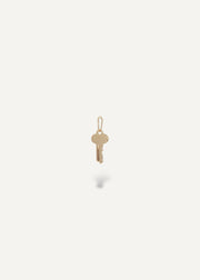 Solid 14k engravable key pendant on a white background from sb studio yeg