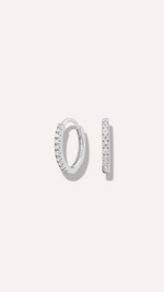 SB Studio Cecilia huggie hoop earrings in 14k white gold with a row of prong-set white topaz gemstones.