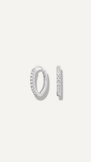 SB Studio Cecilia huggie hoop earrings in 14k white gold with a row of prong-set white topaz gemstones.