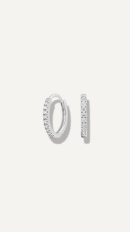 SB Studio Cecilia huggie hoop earrings in 14k white gold with a row of prong-set white topaz gemstones.