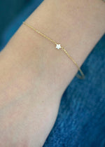 SB Studio Fleur Charm Bracelet in 14k yellow gold featuring a delicate flower charm with white topaz gemstones.