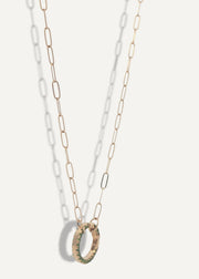 SB Studio gold chain necklace featuring a circular charm holder with green enamel detailing.