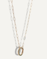 SB Studio gold chain necklace featuring a circular charm holder with green enamel detailing.