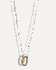 SB Studio gold chain necklace featuring a circular charm holder with green enamel detailing.