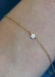 Sb Studio Fleur charm bracelet in 14k yellow gold featuring a delicate flower with white topaz gemstones.