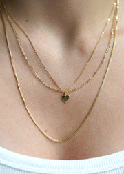 sb Studio 14k yellow gold sweetheart heart charm pendant on a delicate layered gold chain necklace.