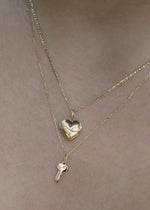 SB Studio gold heart locket and key pendant layered on a delicate cable chain necklace