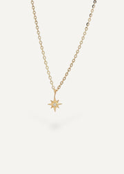 SB Studio 14k yellow gold North Star pendant necklace featuring a small central diamond on a cable chain.