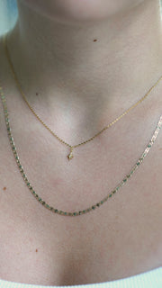 SB Studio Penelope necklace featuring a delicate gold chain with a small star pendant layered with a flat chain.