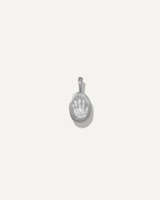 Sb Studio Silver Poet Pendant featuring a small oval sterling silver charm with an engraved paw print design.
