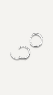 SB Studio Cecilia huggie hoop earrings in white gold with prong-set white topaz gemstones.