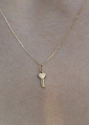 Solid 14k Gold engravable key pendant on a solid 14k chain from sb studio in edmonton