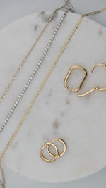 diamond tennis bracelet and necklaces paired with solid 14k gold hoop earrings