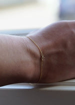 solid gold charm bracelet with bow charm from SB Studio in edmonton alberta
