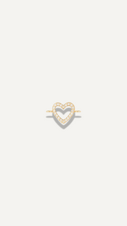 The Sparkle Bar dainty 14k gold bow charm on a delicate cable chain bracelet for everyday minimalist jewelry wear.